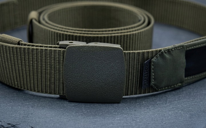 Green belt with a buckle on a blue surface